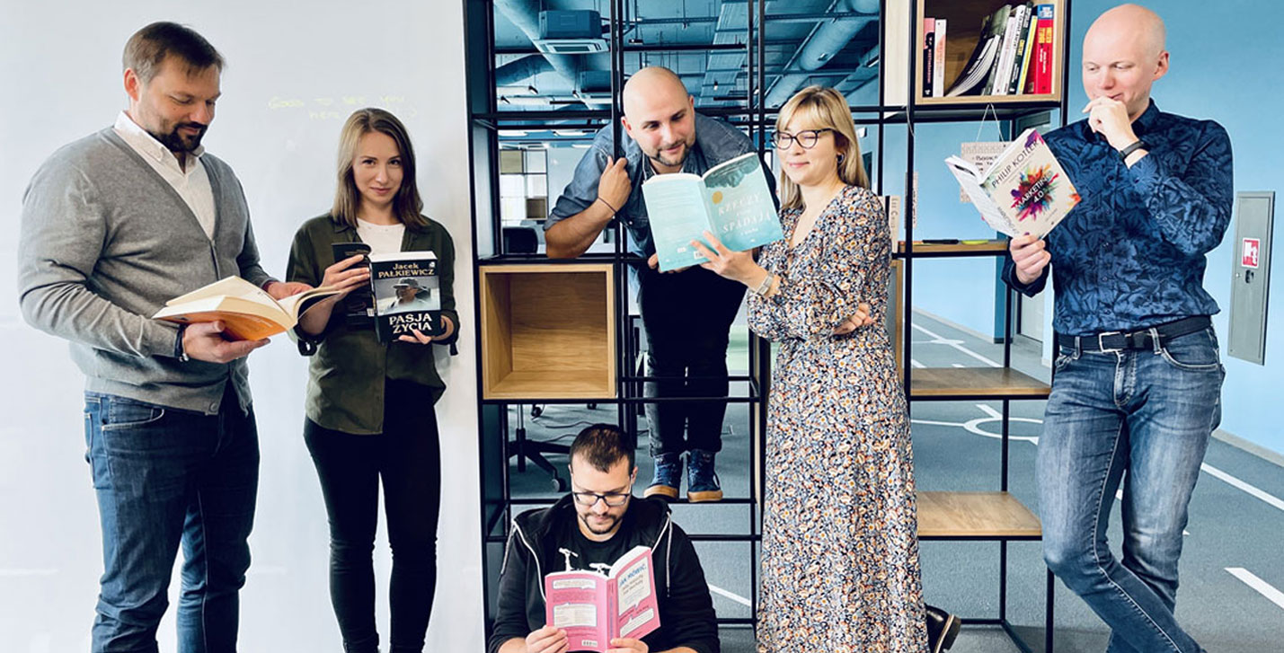 Working at TTC slider image of a group of people reading books in an office