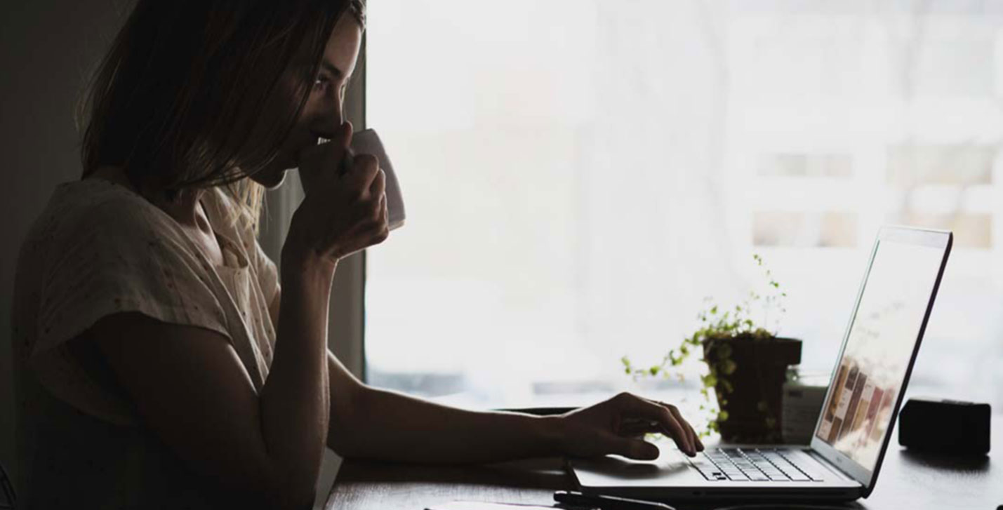 Technology Innovation slider image of a woman on a laptop sipping a hot drink