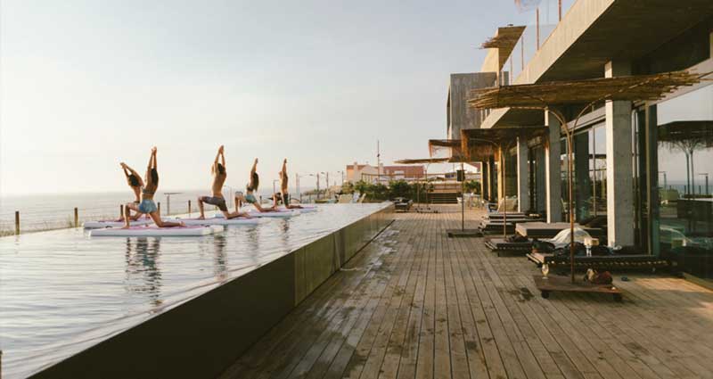 a group of people doing yoga outdoors